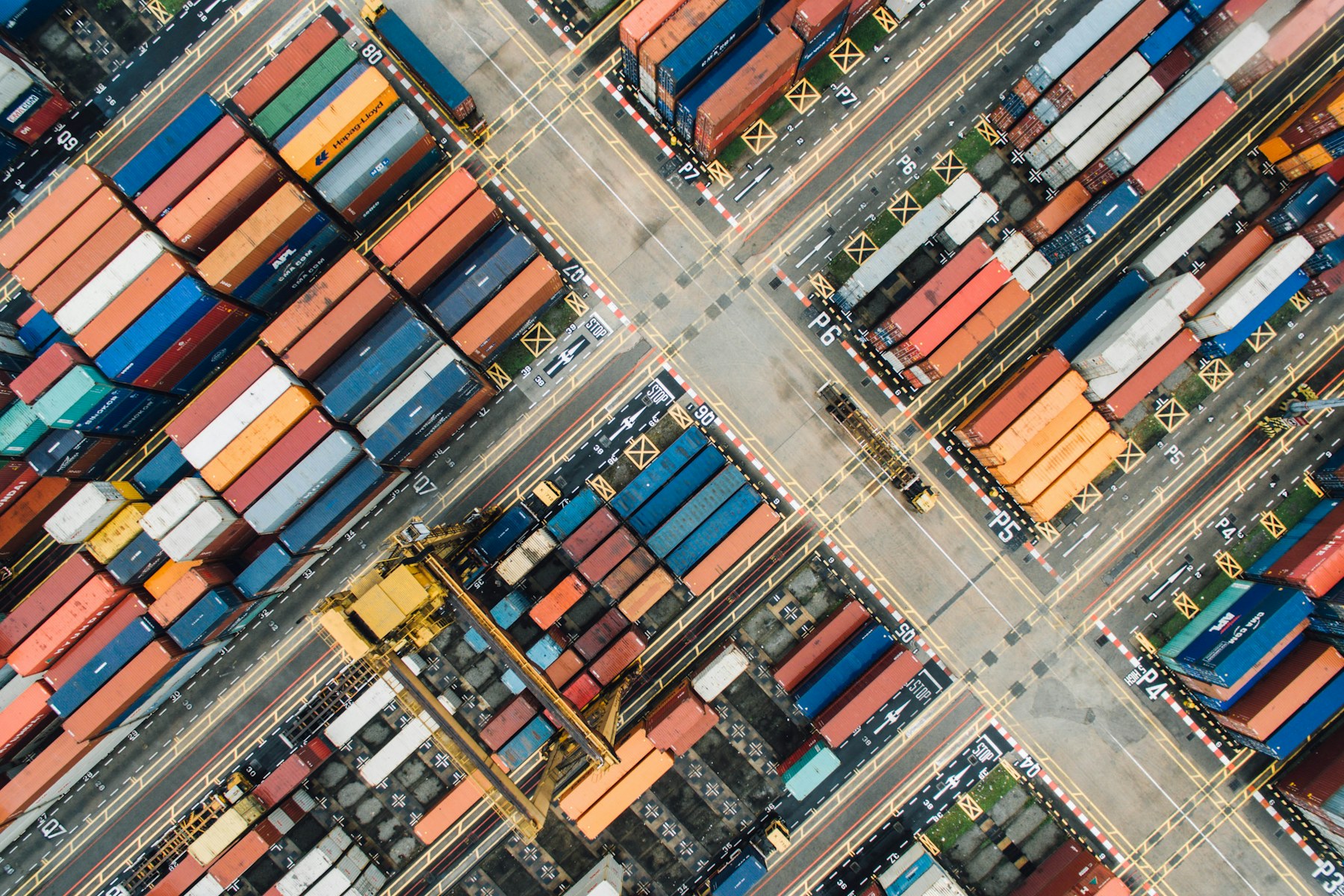 Aerial of a shipping-container yard — logistics as data made physical