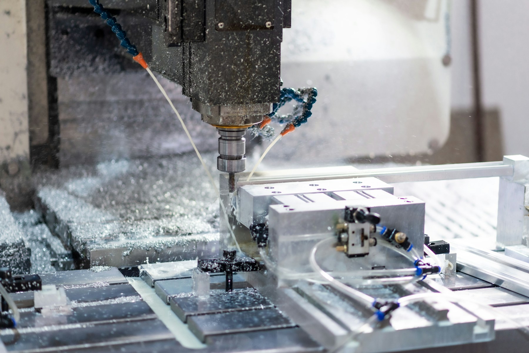CNC machine cutting aluminium with coolant spray